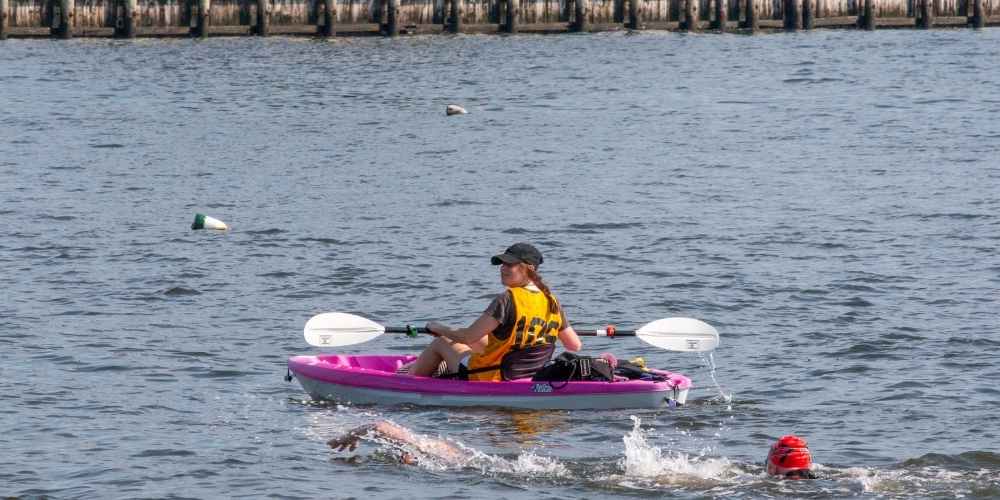 Best Spots for Paddleboarding and Kayaking Near Fire Island Rentals 3 Kayaking on a scenic New York river with forest views and gentle currents